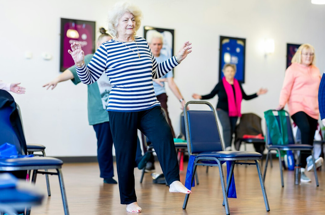 seniors exercising in modern gym